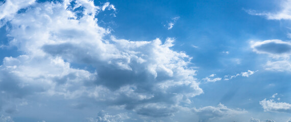 Beautiful view of blue sky with clouds. Beautiful shapes, partly cloudy. Colorful sunset. Natural sky background texture, beautiful color. Bright landscape in the blue sky