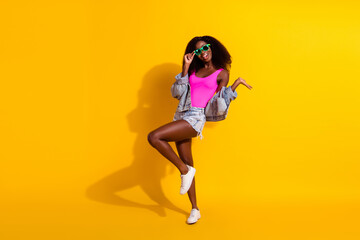 Fototapeta na wymiar Full length photo of brunette pretty afro american lady dance summer mood isolated on yellow color background