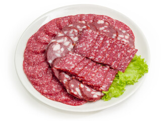 Sliced different dry-cured and smoked sausages on dish