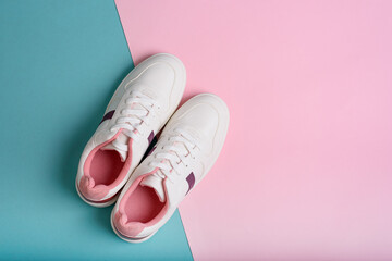 Blue sport sneakers shoes on the blue and pink background.