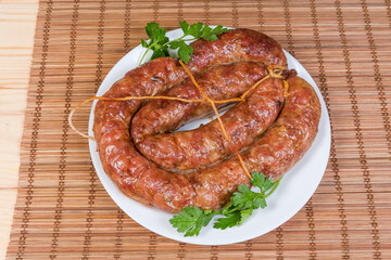 Baked homemade pork sausage curtailed by the rings on dish