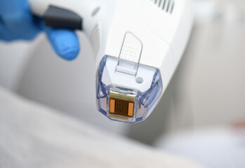 Woman receives laser and ultrasound treatment of face and body and hands in a medical sanatorium, skin rejuvenation concept
