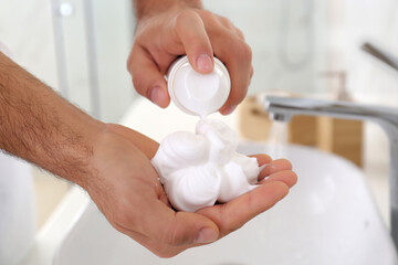 Obraz na płótnie Canvas Man with shaving foam in bathroom, closeup