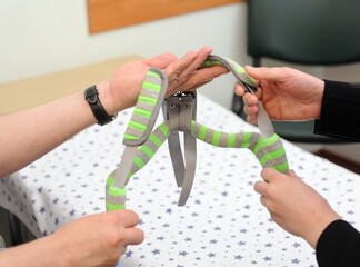 The traumatologist holds an orthopedic corset in his hands.