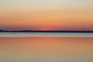 minimalistic photo of sunset over lake Chiemsee in the bavarian alps in Germany