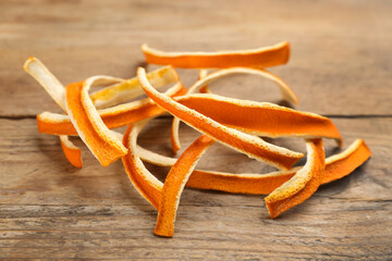 Pile of dry orange peels on wooden table