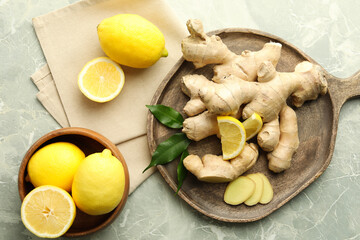 Fresh lemons and ginger on grey marble table, flat lay