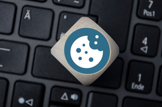 Cube, dice or block with cookie icon on a laptop keyboard