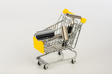 metallic safety razors in shopping cart isolated on white background 