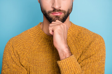 Cropped photo of young handsome attractive serious man thinking hold hand on chin isolated on blue...