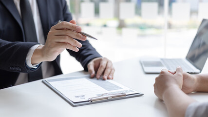 Obraz premium Employer or HR department is reading the resume and interviewing the ability of new employees, Employer is selecting job applicants, Employment and Recruitment Concept.
