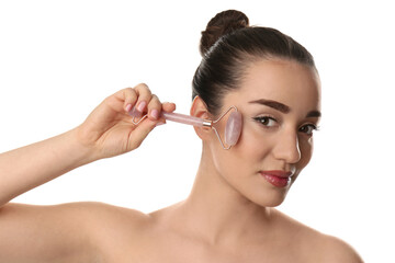 Obraz premium Woman using natural pink quartz face roller on white background