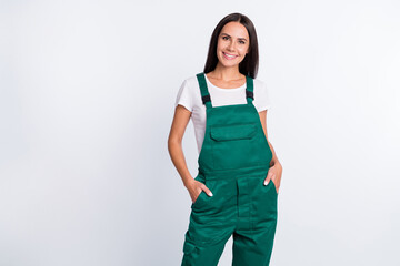 Photo of charming confident lady arms pockets shiny smile wear green overall isolated white color...