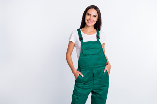 Photo of charming confident lady arms pockets shiny smile wear green overall isolated white color background