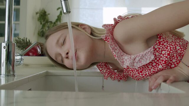 Girl tries drink tap water