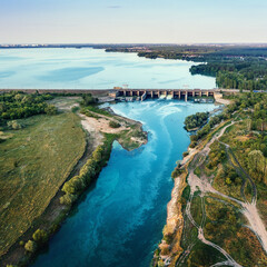 Hydroelectric dam on river with beautiful nature landscape, aerial view.