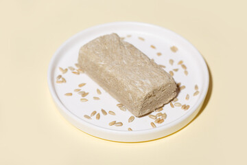 Halva from sunflower seeds on a colored background. Traditional oriental sweets. Jewish, Turkish, Arabic national dessert. Oriental sweets concept