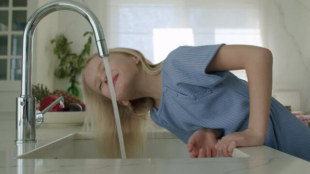 Girl tries drink tap water