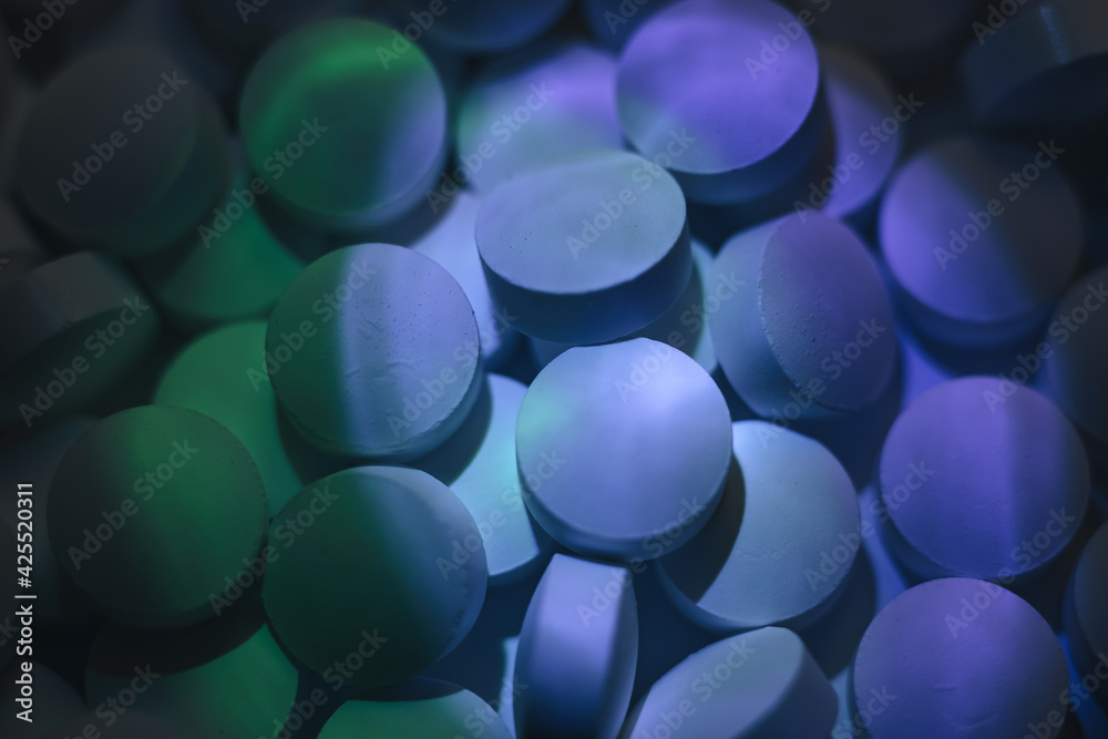 Poster pills or drugs in a package under neon light. beautiful background pattern for design.
