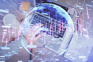 Double exposure of man's hands typing over computer keyboard and forex graph hologram drawing. Top view. Financial markets concept.