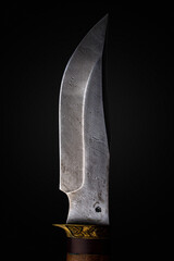 Knife of Damascus steel. Patterned blade close-up.