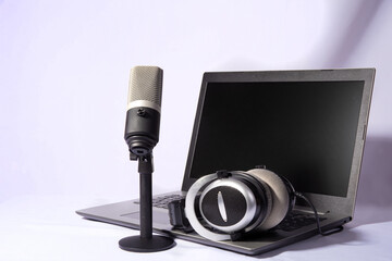 Fototapeta na wymiar home work, professional condenser microphone, computer and headset on light background, selective focus.