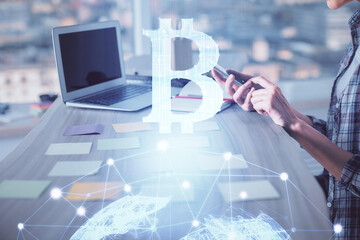 Double exposure of woman hands typing on computer and crypto market theme hologram drawing....