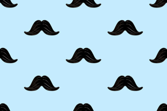 Black mustache seamless pattern on a blue background. Happy father's day and masculinity concept. Retro stylish design for wrapping paper, fabrics, man textiles, clothes for a boy