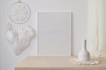White photo frame mockup with white dream catcher on white wall