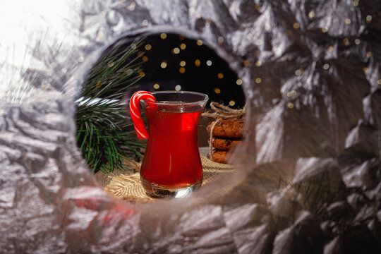Hot tea on a winter evening. Armuda with tea. Look into the house through the frozen window. Selective focus.