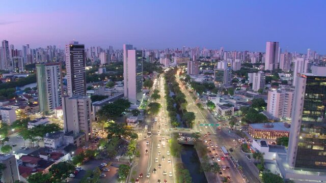 26 AERIAL IMAGE CLOSE TO AVENIDA AGAMENON MAGALHAES, IN THE CITY OF RECIFE, PERNAMBUCO, BRAZIL, ILLUMINATED DURING SUNSET WITH TREES AND CARS PASSING BELOW