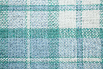 Turquoise woolen fabric with geometrical pattern as background, top view