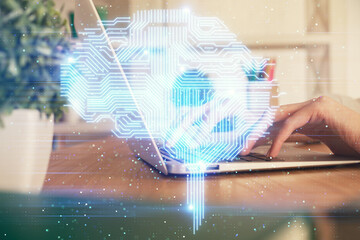 Double exposure of woman hands working on computer and brain hologram drawing. Ai concept.