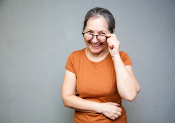 Russian woman 55 years old smiling on   gray