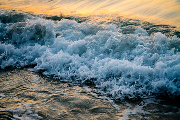Ocean water at sunset with waves crushing