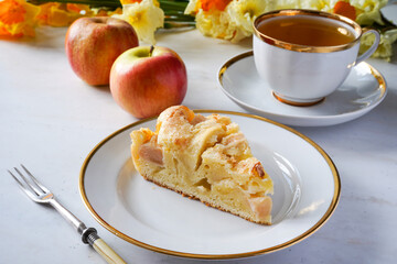 Plate with piece of tasty homemade apple pie on white background 
