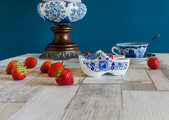 Typical Dutch blue  clogs souvenir with fresh strawberries.