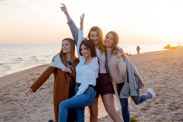 Group of friends having fun on the beach, meeting friends. Young women