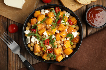 Delicious fresh chickpea salad served on wooden table, flat lay