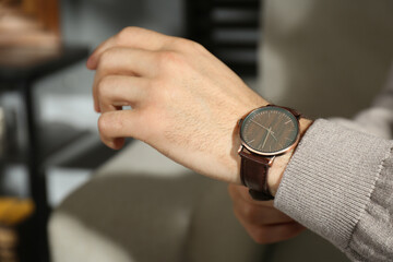 Obraz na płótnie Canvas Man with luxury wrist watch indoors, closeup