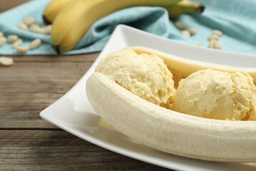 Delicious banana split ice cream on wooden table, closeup