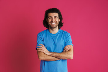 Joyful brunette man in t-shirt smiling and looking at camera