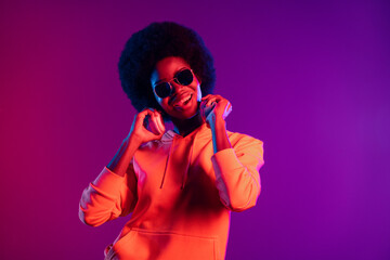 Photo of crazy dj girl have fun open mouth wear sweatshirt earphones sunglass isolated gradient...