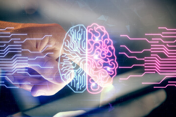 Double exposure of man's hand holding and using a digital device and brain hologram drawing. Data...
