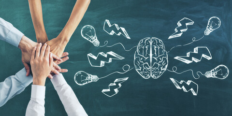 Brainstorming and teamwork concept with six hands on green chalkboard and brain hemispheres and...