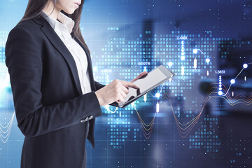 Businesswoman holding a tablet with charts in the background, city view, data and market analysis concept. Double exposure