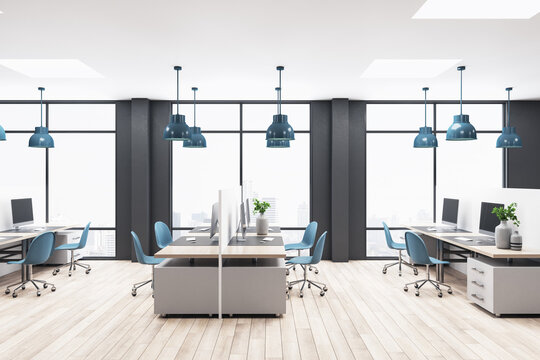 Bright empty coworking space with computers, blue chairs, big windows, black walls, wooden floor and concrete ceiling, coworking interior concept. 3d rendering