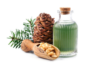 Pine oil and pine nuts with cedar cone on white backgrounds