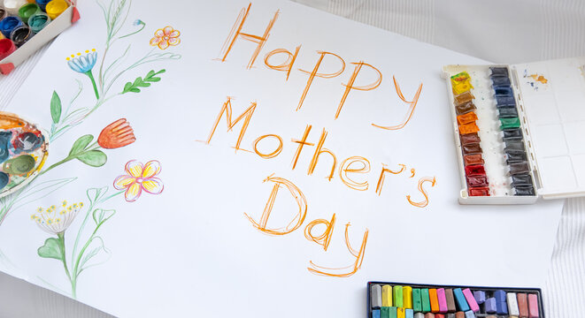 Children's drawing for mother's day and paints with crayons.