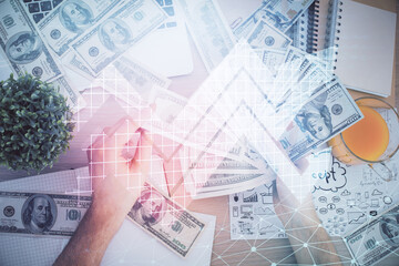 Multi exposure of arrows drawing hologram and USA dollars bills and man hands. Growth concept.